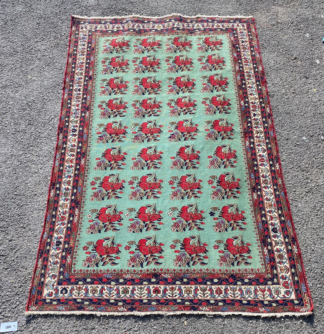 A Kirman Shah rug woven with floral bunches on a green ground within a conforming multi border, 184cm X 120cm
